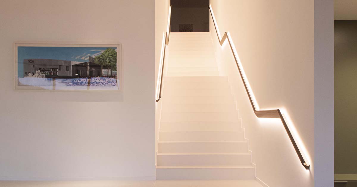 led-lighting-above-and-below-the-handrail-illuminates-these-stairs