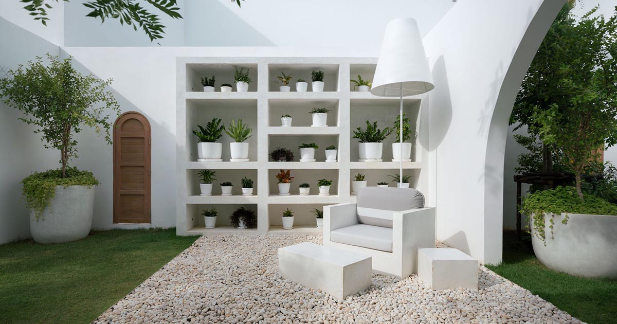 this-landscaped-outdoor-space-includes-a-living-room-with-a-bookshelf-for-plants