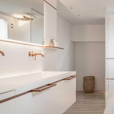 copper-tones-are-balanced-by-white-corian-in-this-minimalist-bathroom