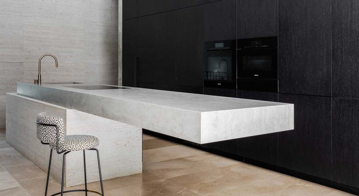 a-cantilevered-island-is-a-dramatic-feature-in-this-minimalist-kitchen
