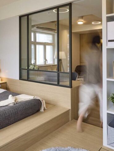 the-internal-window-in-the-bedroom-of-this-small-apartment-allows-light-into-the-living-room