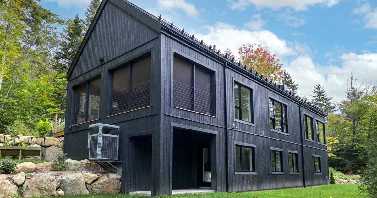 all-black-wood-siding-creates-a-striking-exterior-for-this-new-house
