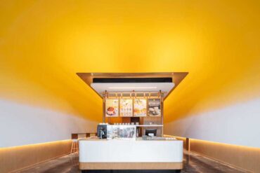 this-pancake-cafe-used-a-bold-yellow-to-highlight-its-curved-ceiling