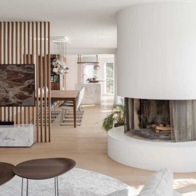 a-round-fireplace-is-a-unique-feature-in-the-living-room-of-this-remodeled-home