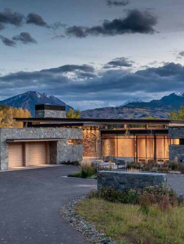 clad-in-stone,-wood,-steel,-and-glass,-this-house-nestles-quietly-within-the-natural-surroundings