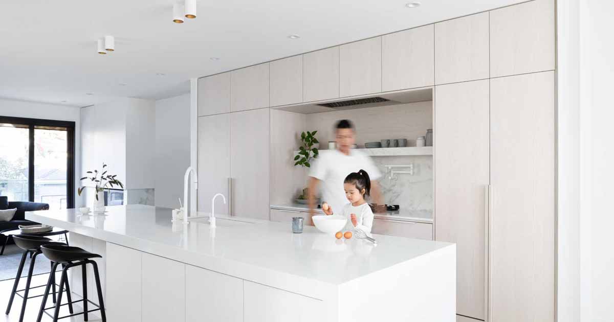 white-stained-oak-cabinets-paired-with-cool-white-marble-creates-a-soft-aesthetic-inside-this-home