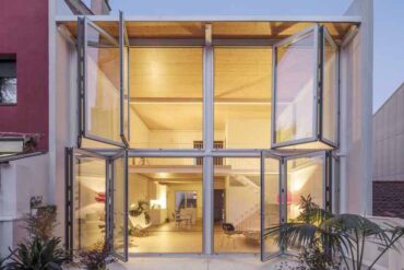 large-folding-glass-walls-open-this-home-to-a-courtyard