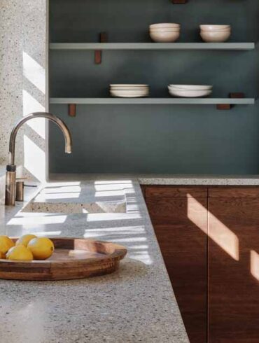 a-seamless-terrazzo-flows-from-the-wall-to-the-countertop-in-this-kitchen