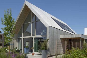 this-barn-inspired-home-hides-a-playroom-with-climbing-wall-under-its-gable-roof