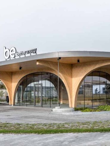 large-wood-arches-dramatically-elevate-the-roof-of-this-charging-station