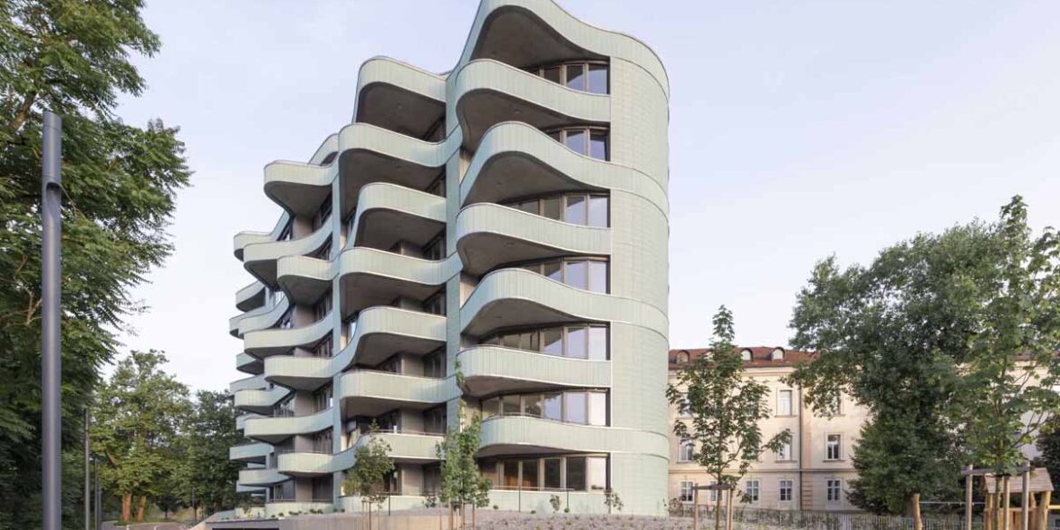 undulating-balconies-and-a-mint-green-tiled-exterior-give-this-new-building-a-unique-look