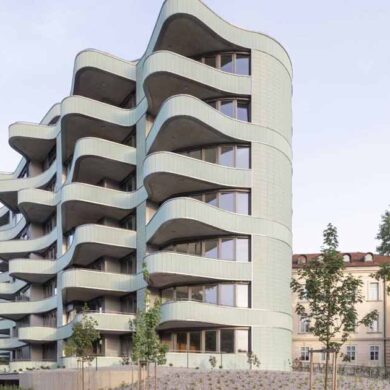 undulating-balconies-and-a-mint-green-tiled-exterior-give-this-new-building-a-unique-look