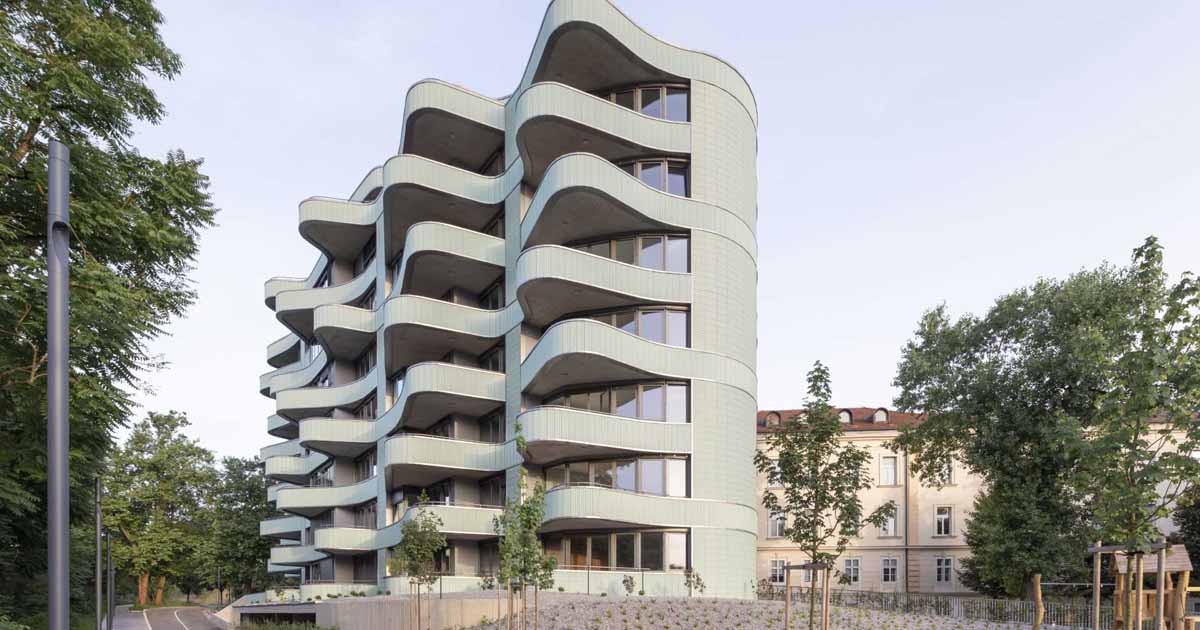 undulating-balconies-and-a-mint-green-tiled-exterior-give-this-new-building-a-unique-look