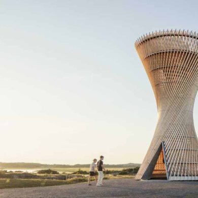 an-observation-tower-that-looks-like-twisted-wood-rises-above-the-swedish-landscape